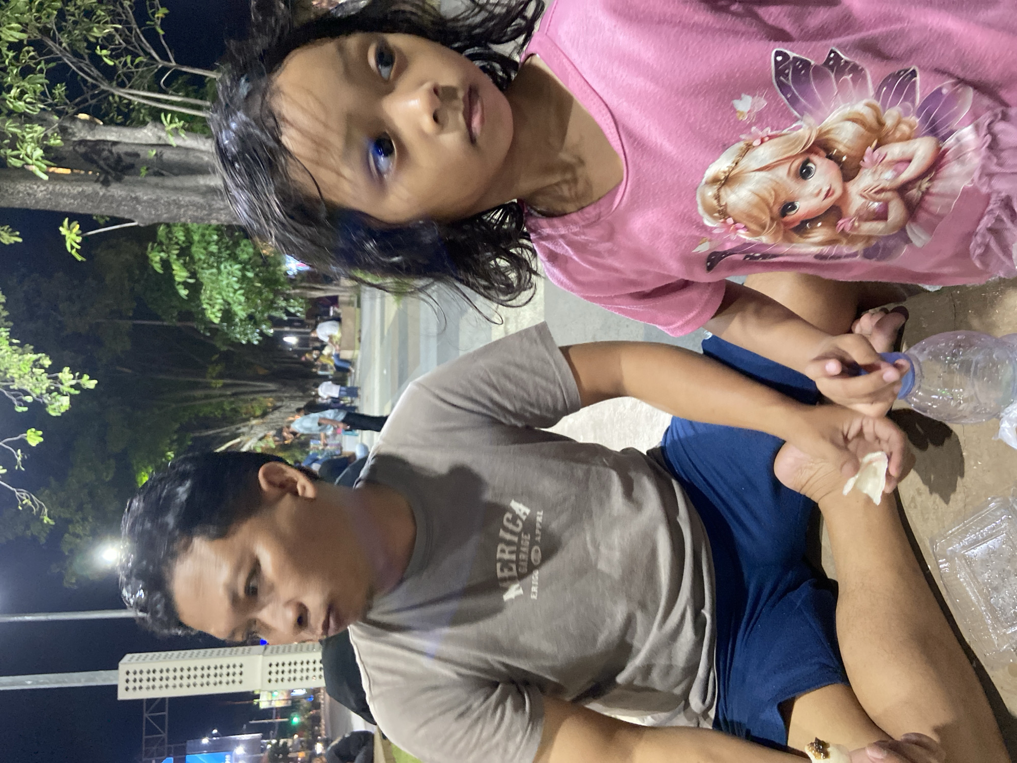 Evening out at a Sidoarjo park: roller skates, snacks, and street life.