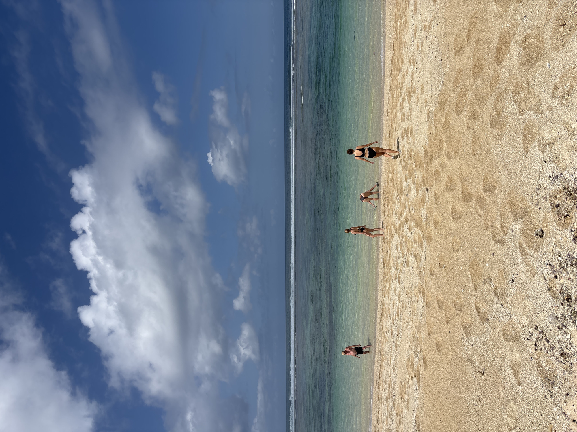 Paragliders soaring over Kuta Selatan's cliffs and beach
