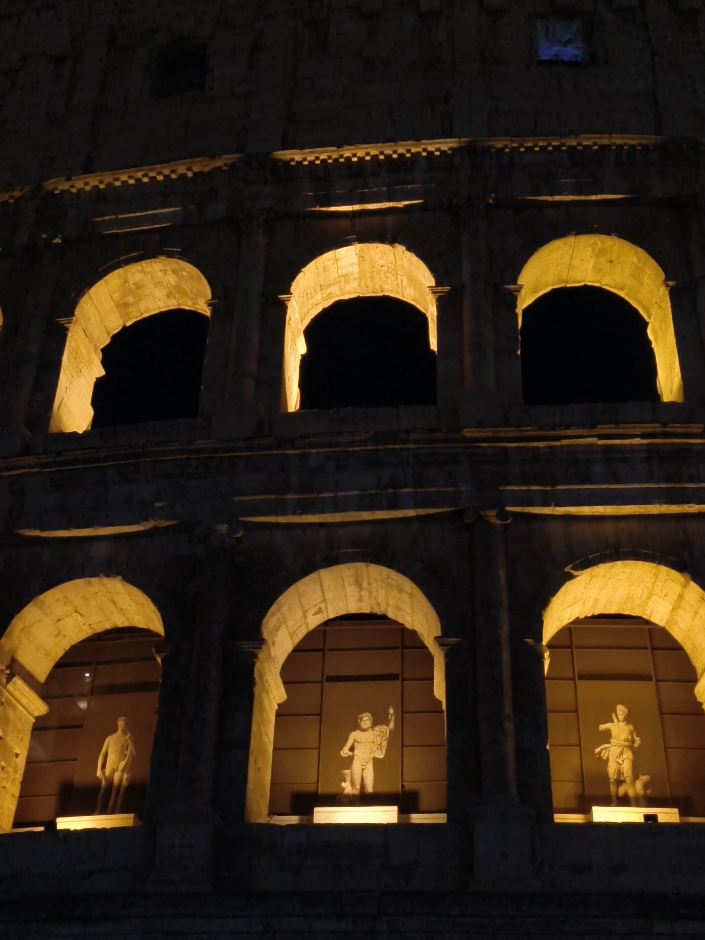 Nighttime Colosseum illuminated in Rome captures witness attention