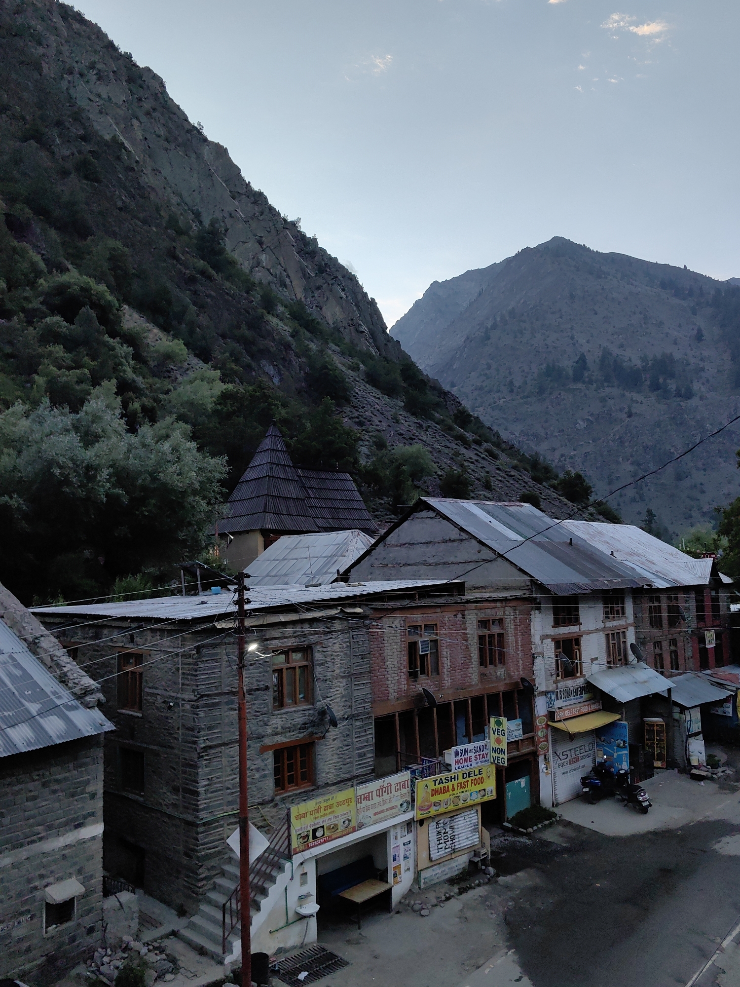 Mountain villages and hazy Himalayan peaks at dusk