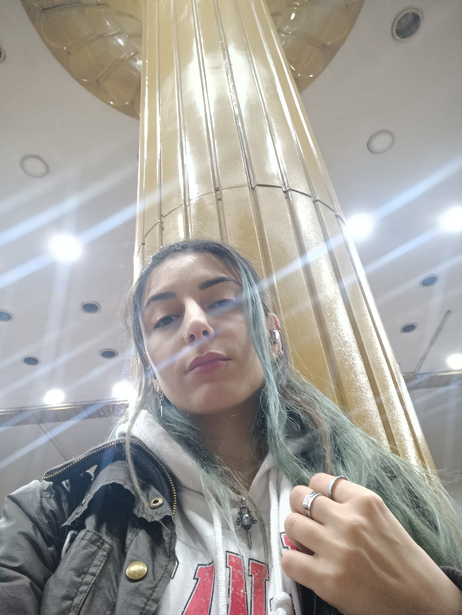 Young woman with teal hair films selfies in Baku