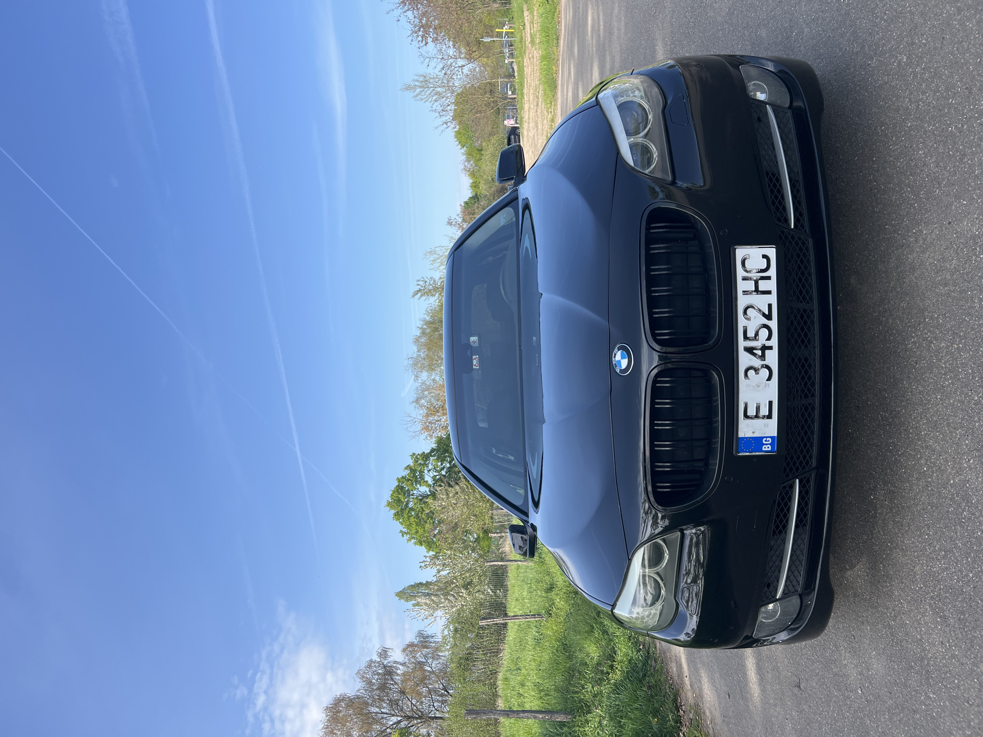 Bulgarian BMW parked on rural road amid greenery