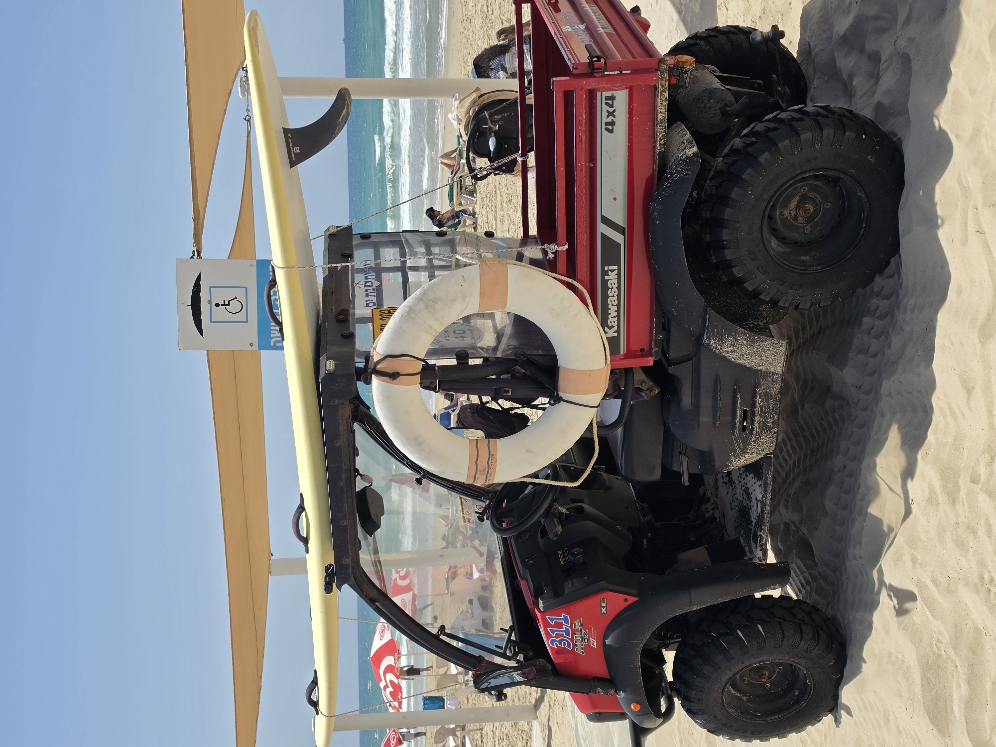 Utility vehicle with surfboard spotted on sunny Bat Yam beach