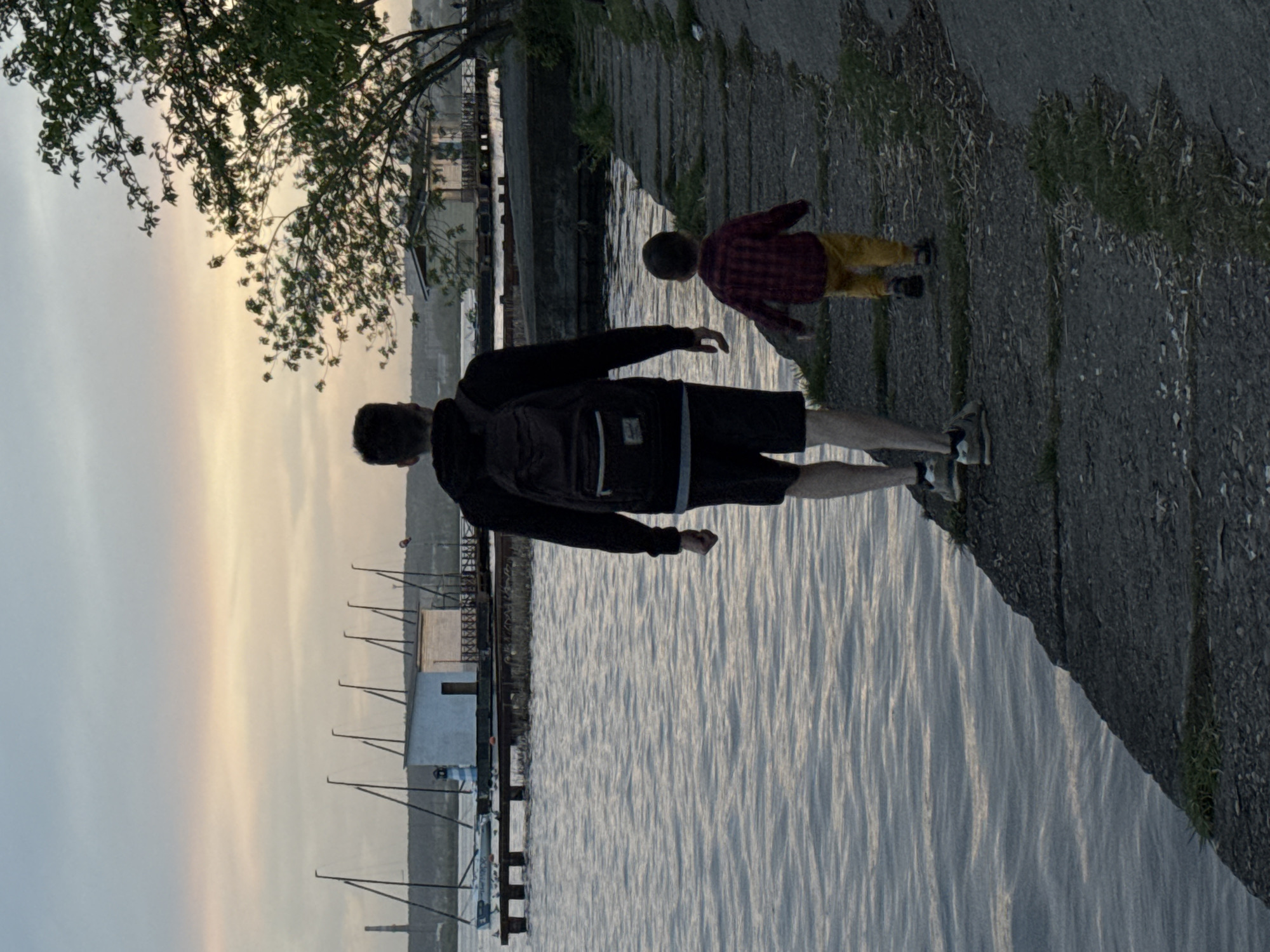 Father and child visit Izhevsk waterfront on spring afternoon
