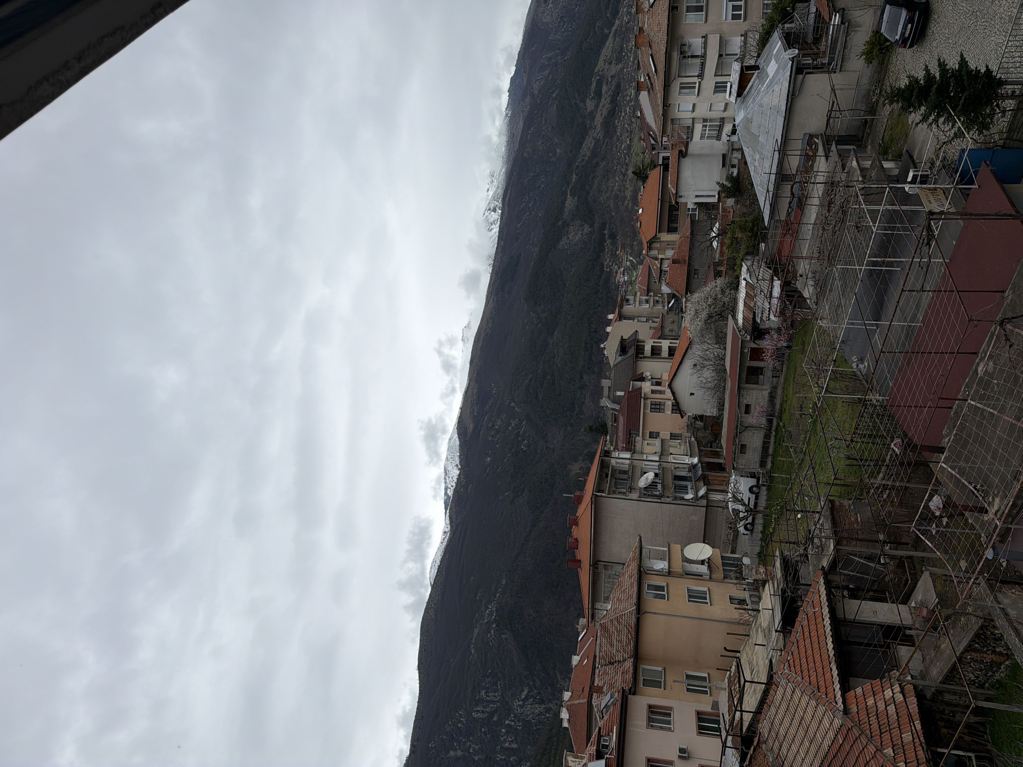 Overcast view captures Karlovo's residential landscape against mountain backdrop