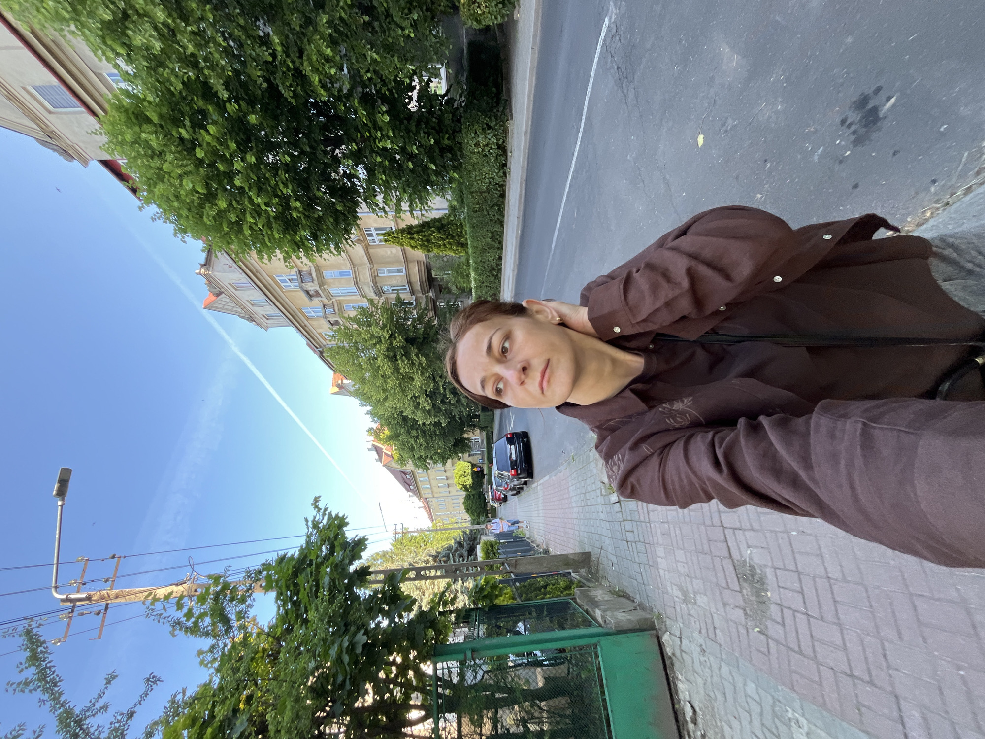 Woman documents morning coffee walk through urban construction zone