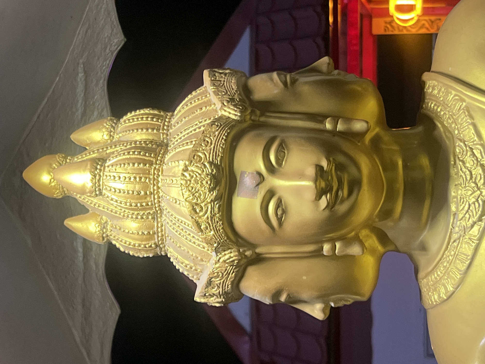 Golden four-faced Brahma statue at a Pa Khlok shrine