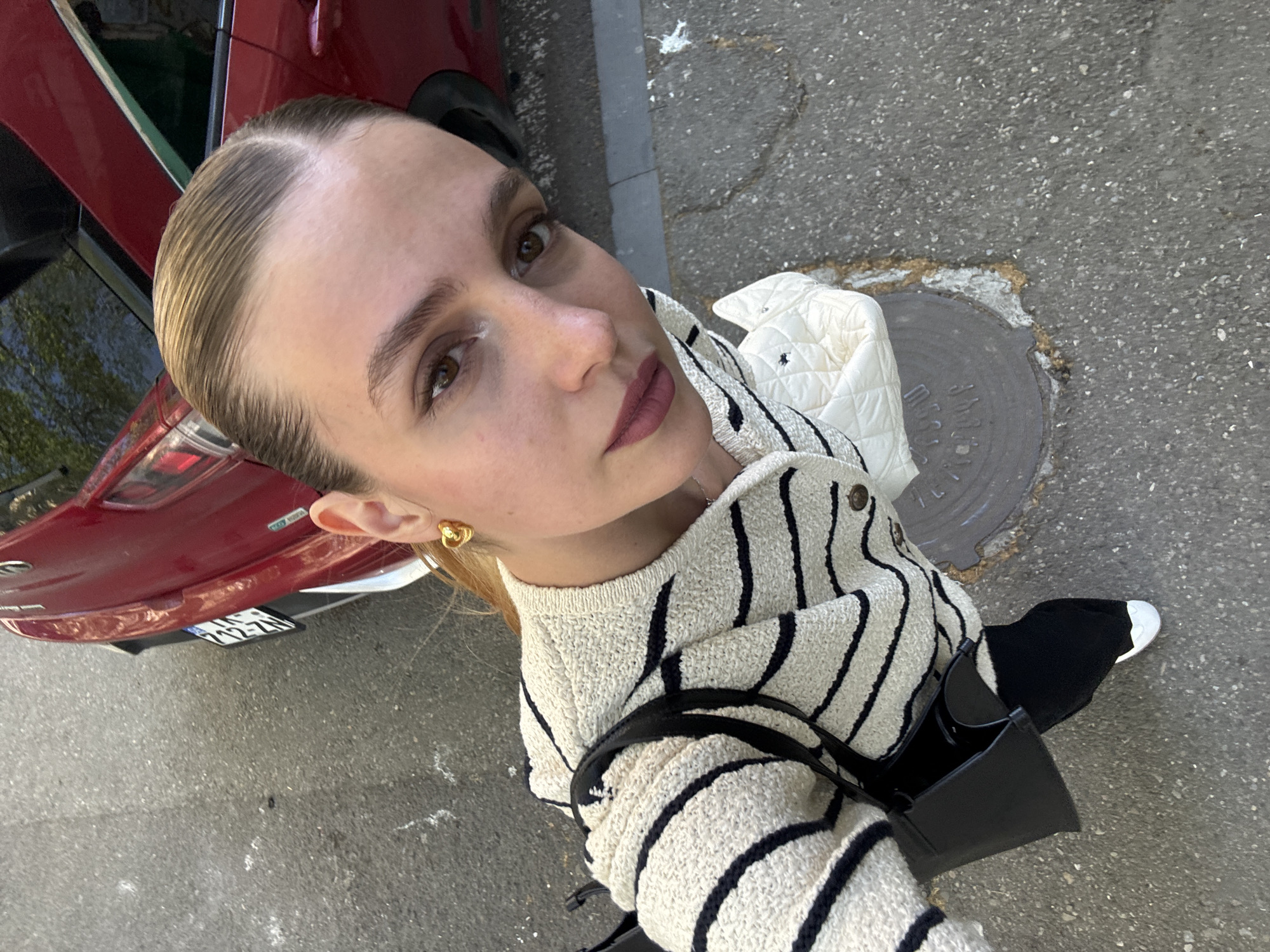 Woman Takes Upward-Angled Selfie in Downtown Tbilisi