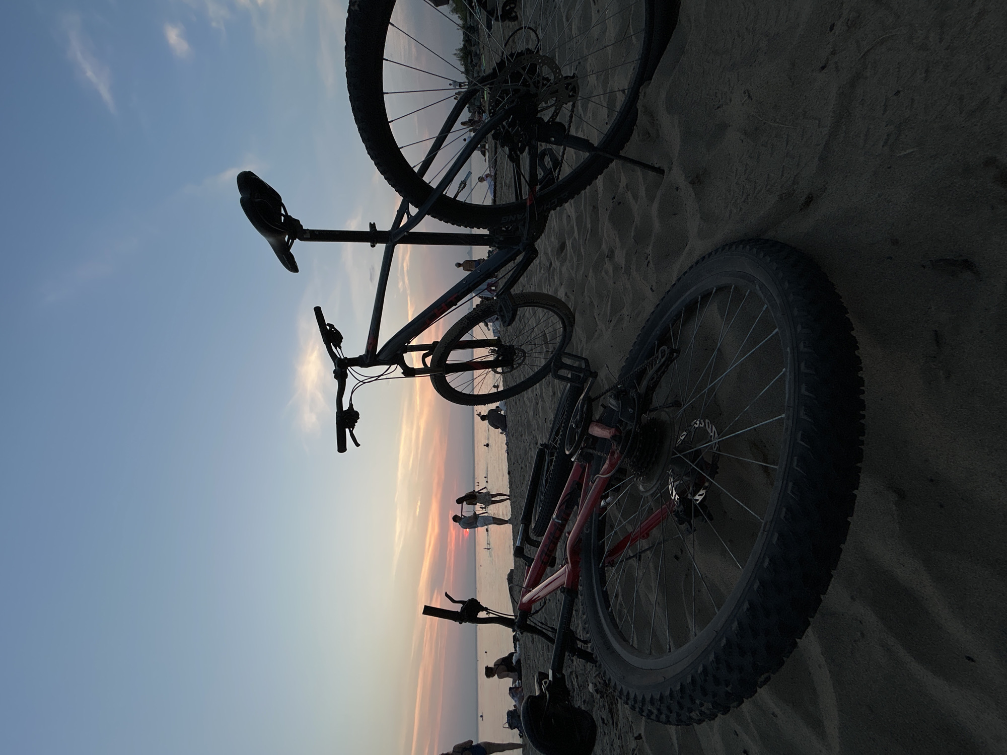 Sunset swim session at a Berdsk beach, bikes parked on sand