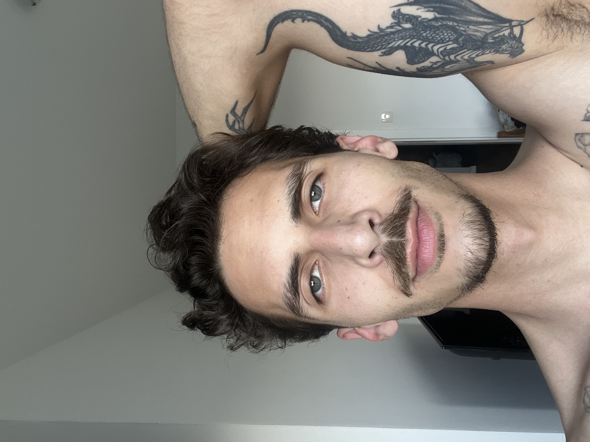 Tattooed man observed in Rafailovići Montenegro interior setting