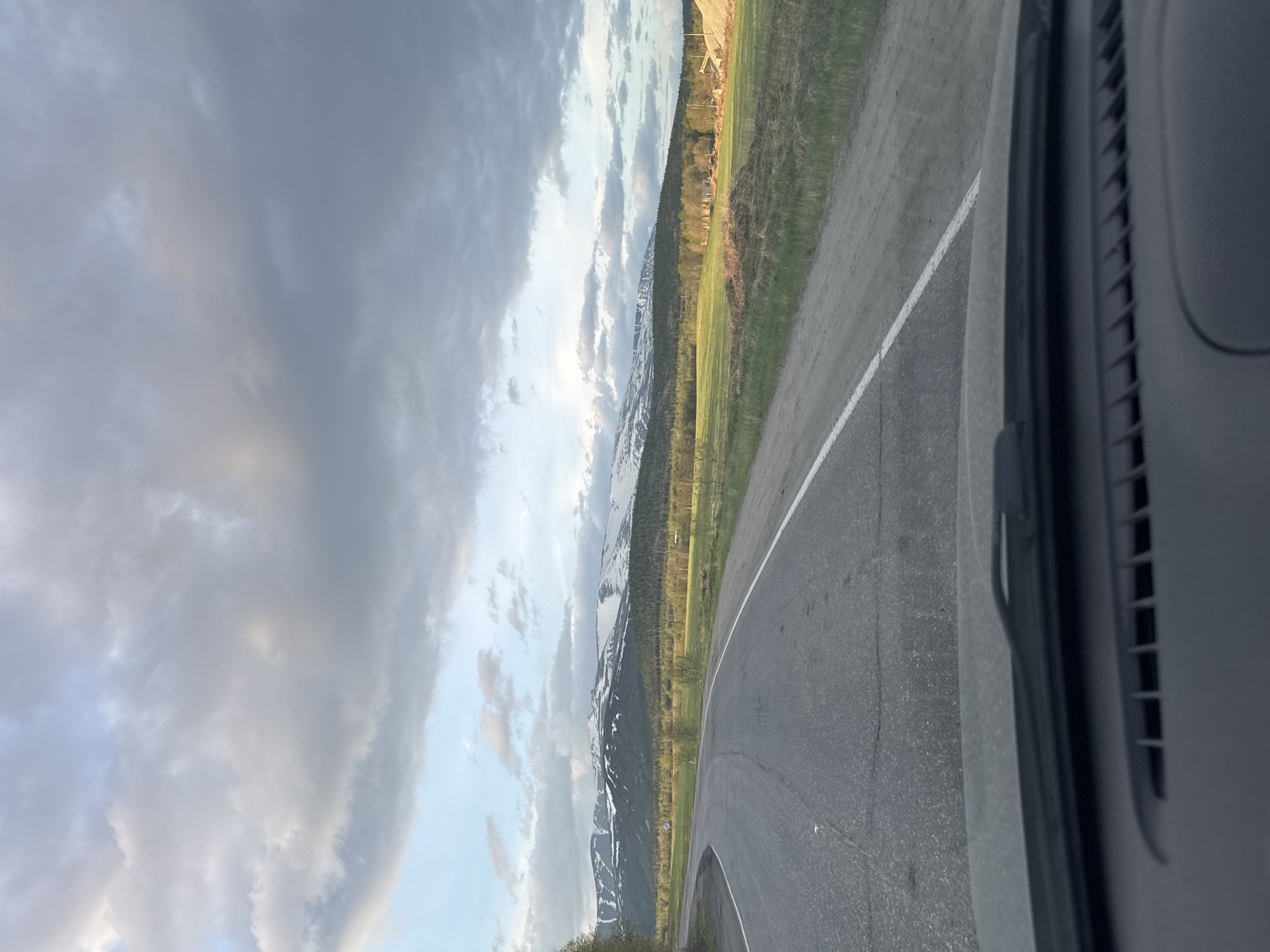 Vehicle travels curving mountain road in Titan, Russia