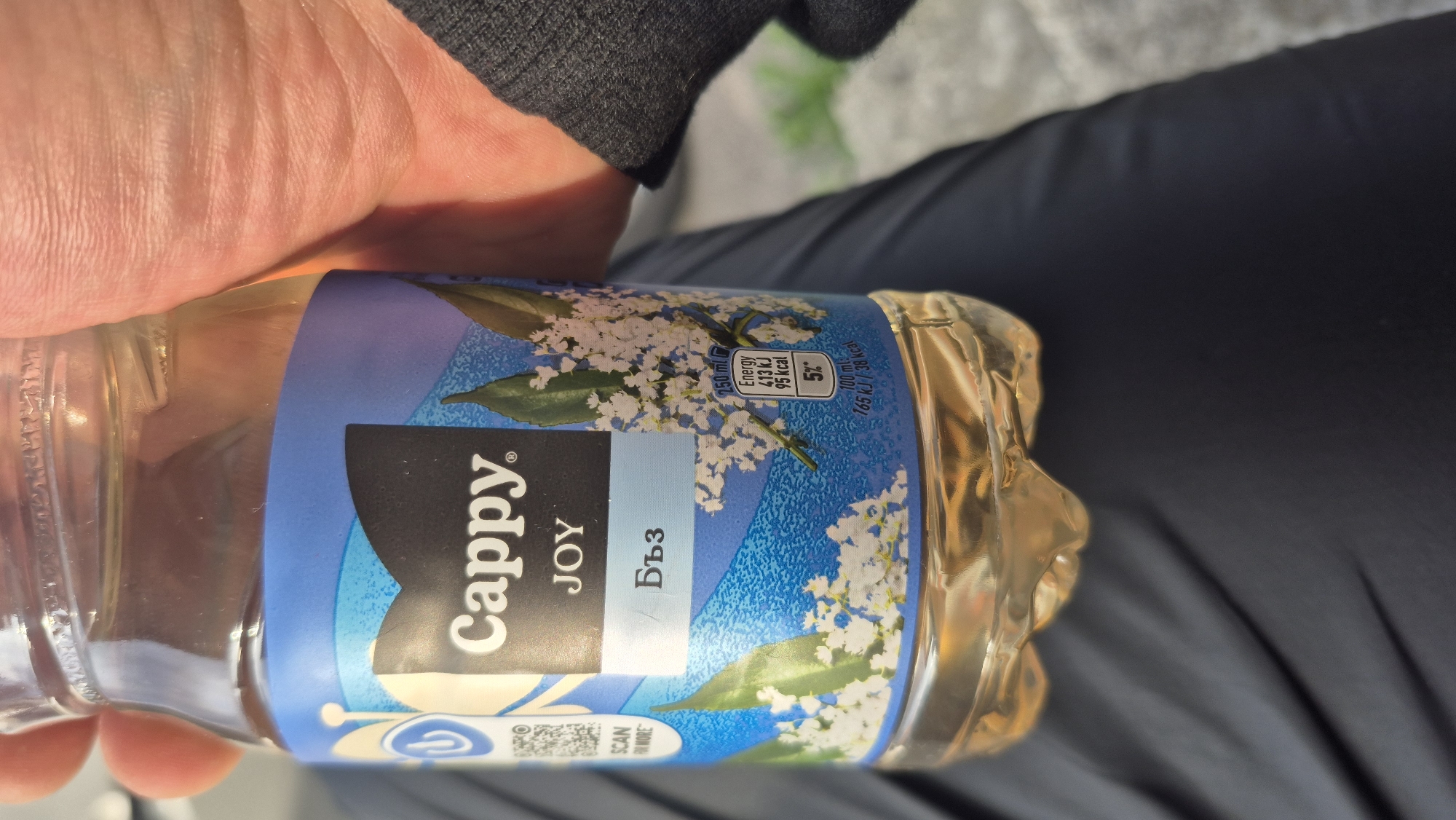 Person holds elderflower drink in Pernik, Bulgaria