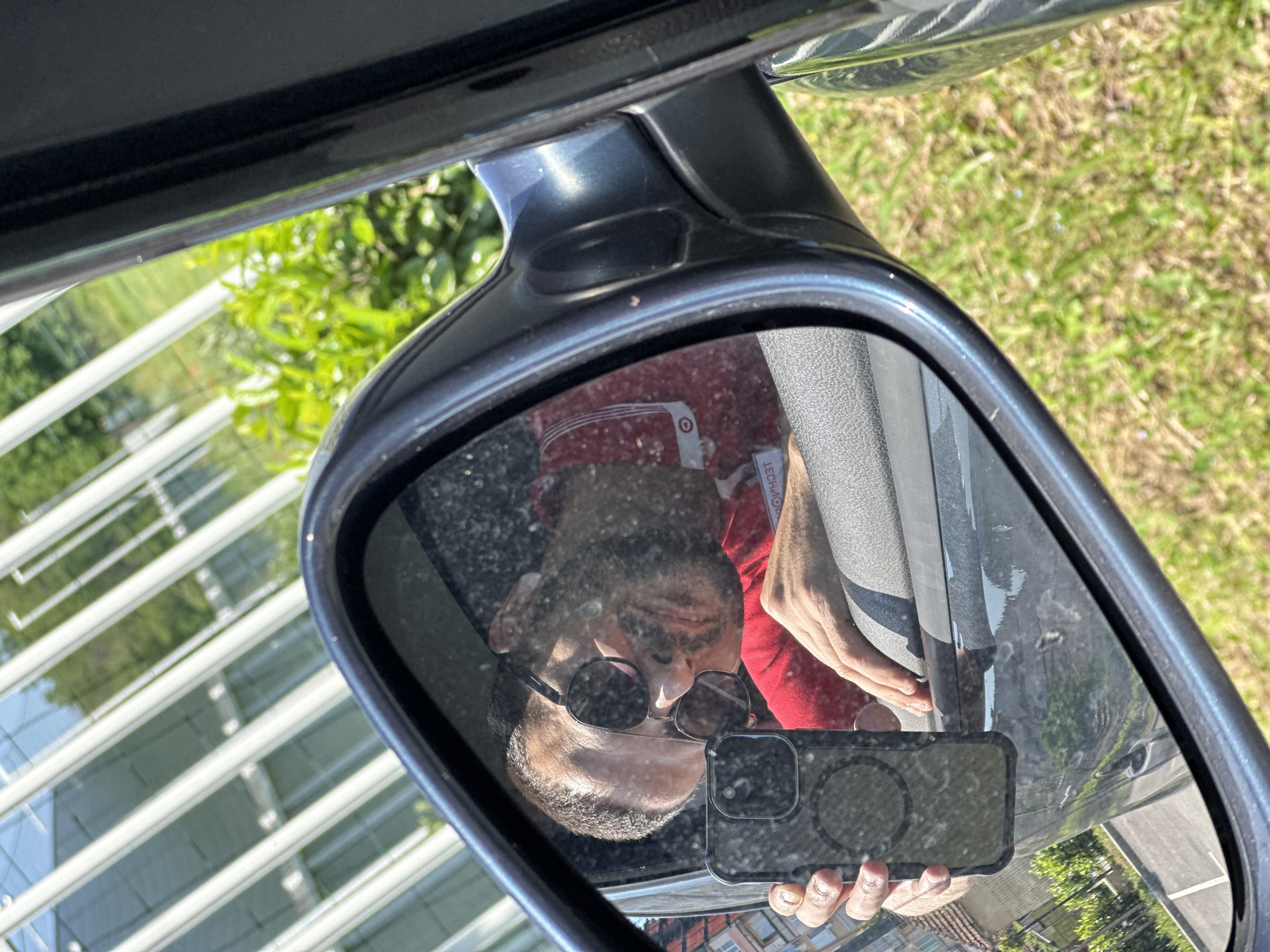 Person captures self-reflection in car mirror in Lovech