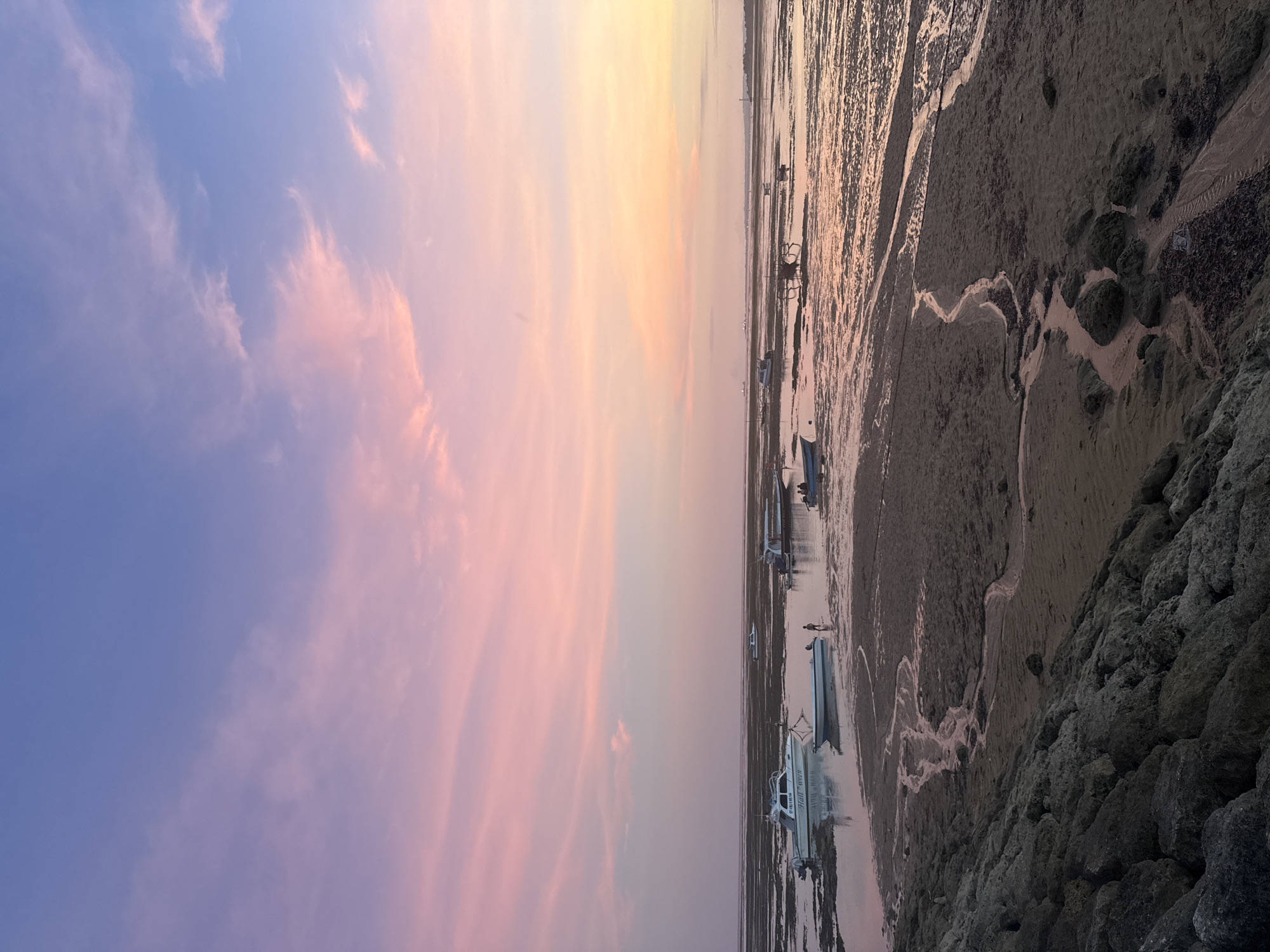 Vibrant sunset observed over Denpasar coast during low tide