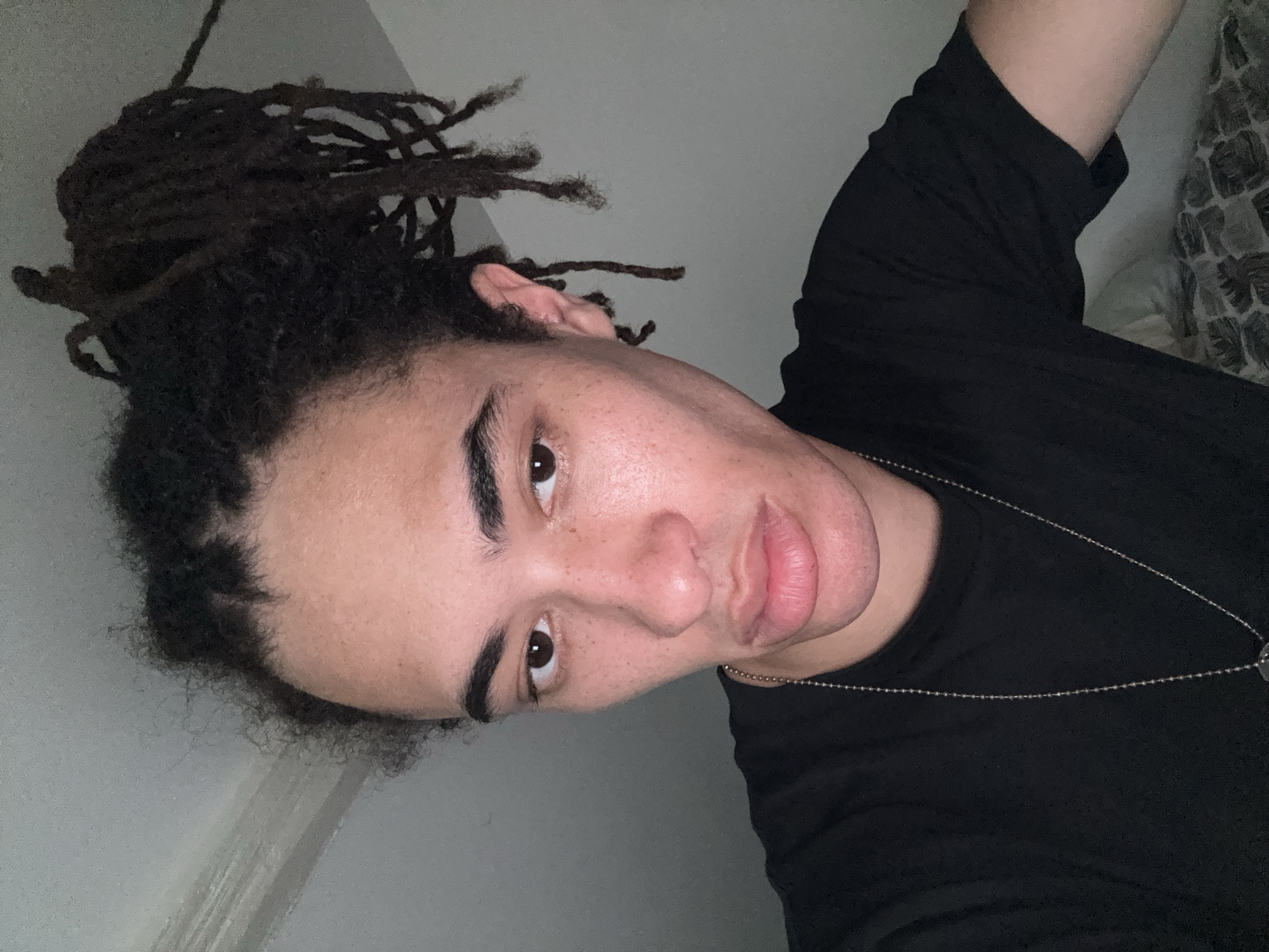Low-angle selfie session in Paris, dreadlocks and silver necklace
