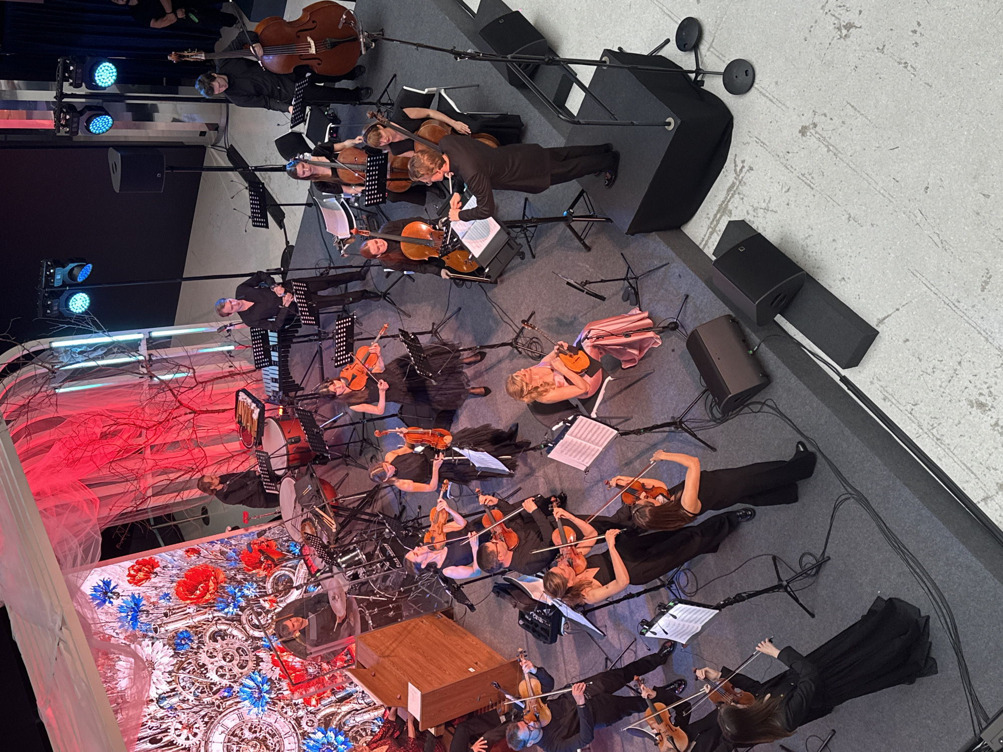 Overhead view of a full orchestra performing live on stage