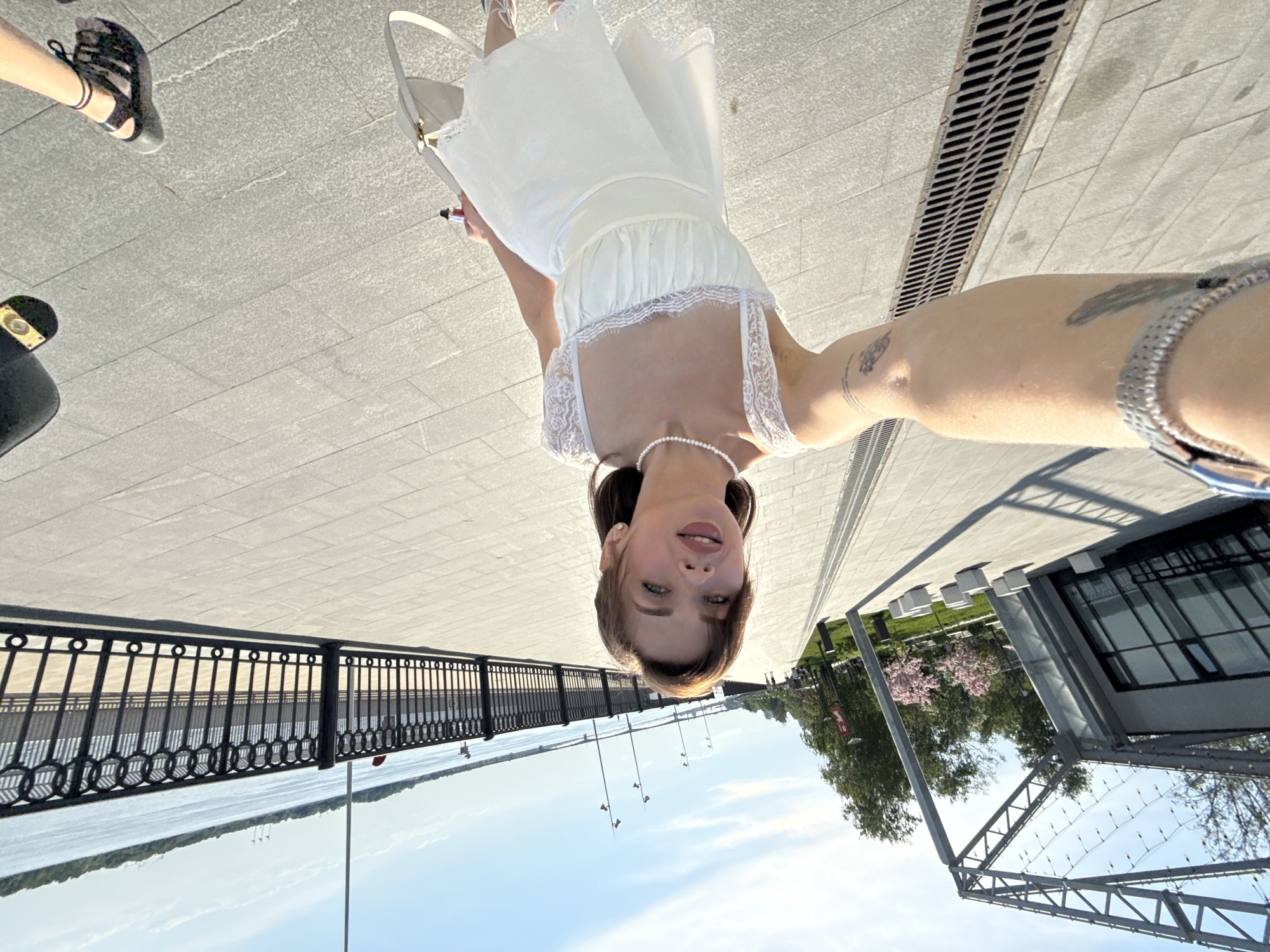 Woman photographs spring outing along Perm's Kama River embankment