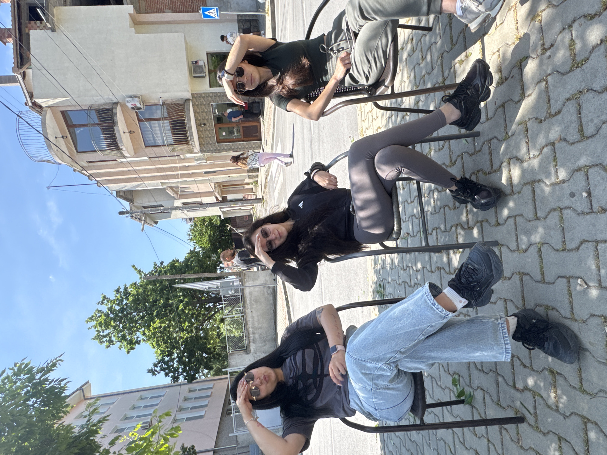 Young people gather for casual street meetup displaying tattoos