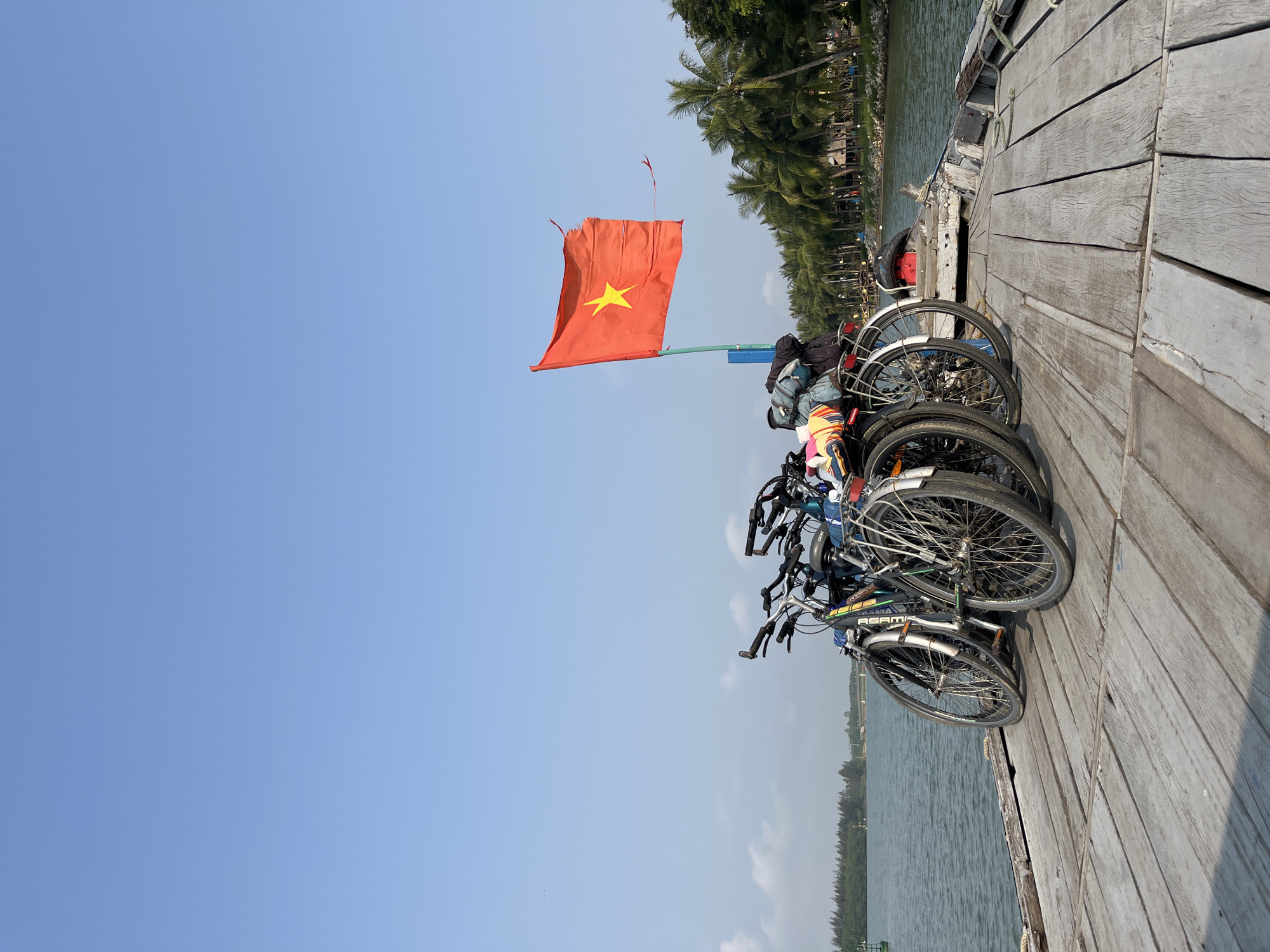 Bicycles transported on wooden boat deck in Hội An