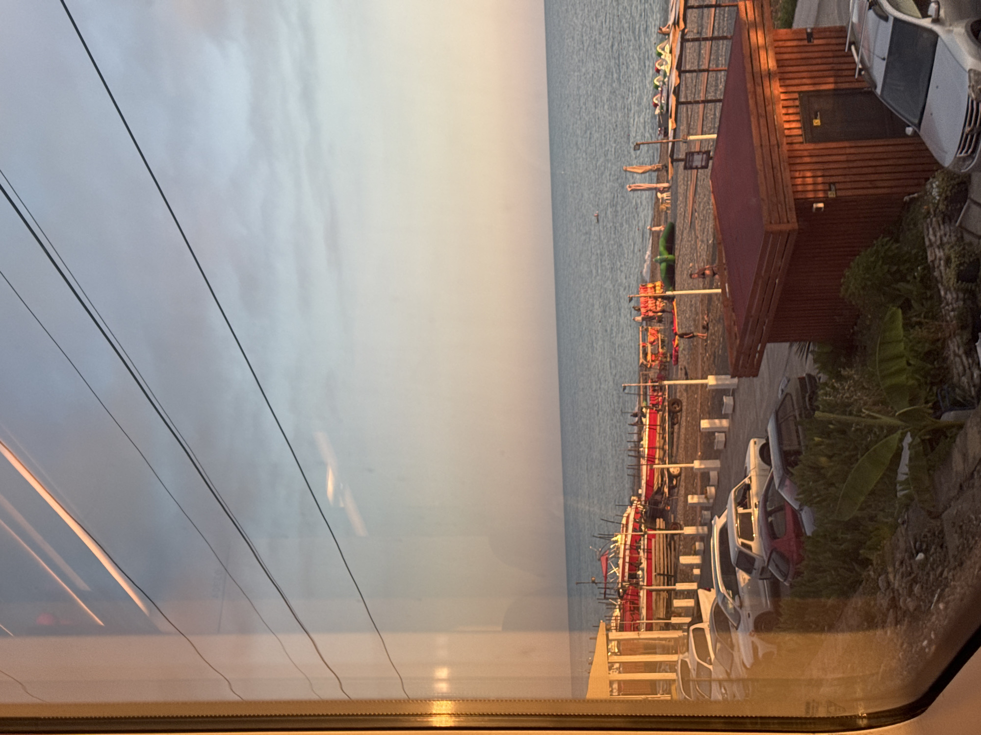 Sochi's Black Sea waterfront at golden hour, seen from land and rail
