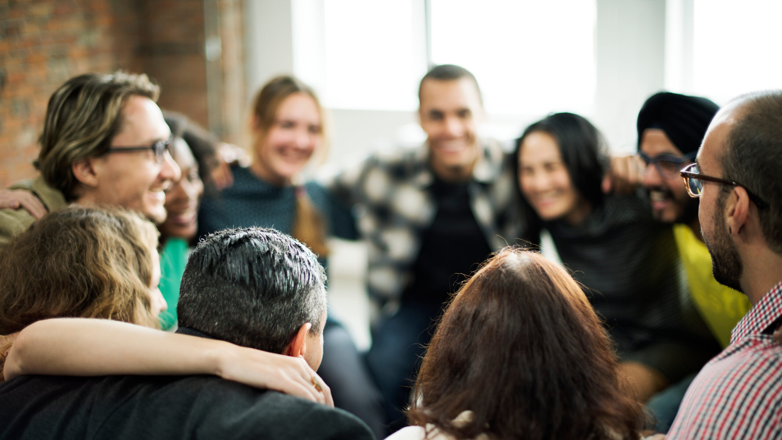 Happy people huddling in a room