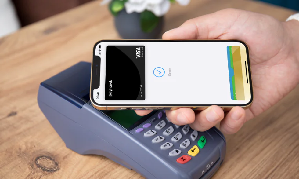 Payhawk Apple Pay-supported corporate visa card used on a POS terminal
