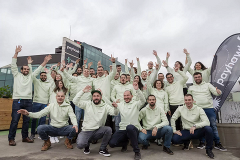 Payhawk team posing in front of our main office. 