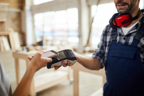 Employee paying with an expense card for employees at the counter