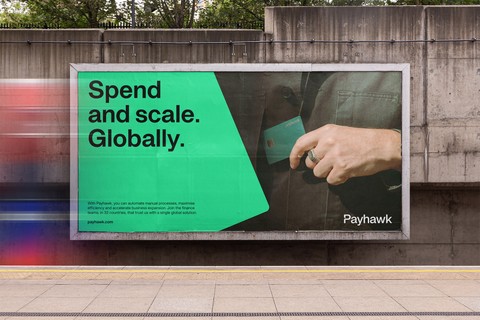 Photo d'un panneau d'affichage présentant les nouvelles couleurs de la marque de solutions de dépenses d'entreprise, Payhawk. 