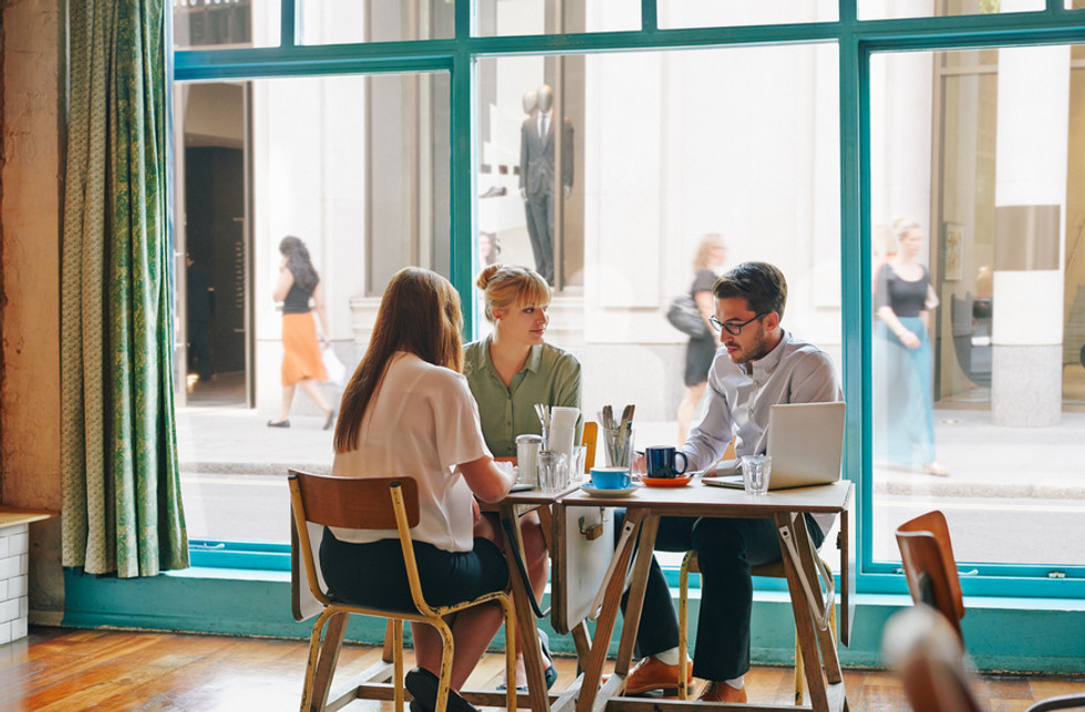 Employees discussing Payhawk's automated expense management features