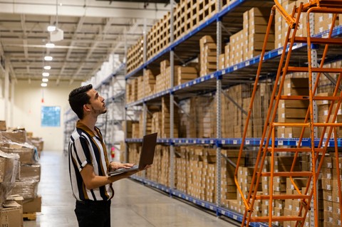 Accountant in warehouse, researching our Benefits of Spend Management Solution & NetSuite ERP Integration