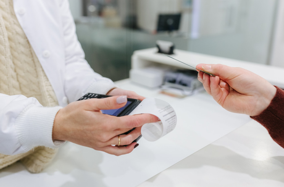 Employee reconciling expenses using a POS terminal using Payhawk's spend management solution 