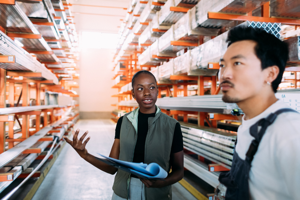 A supplier management discussing supplier data from the report with his warehouse employee