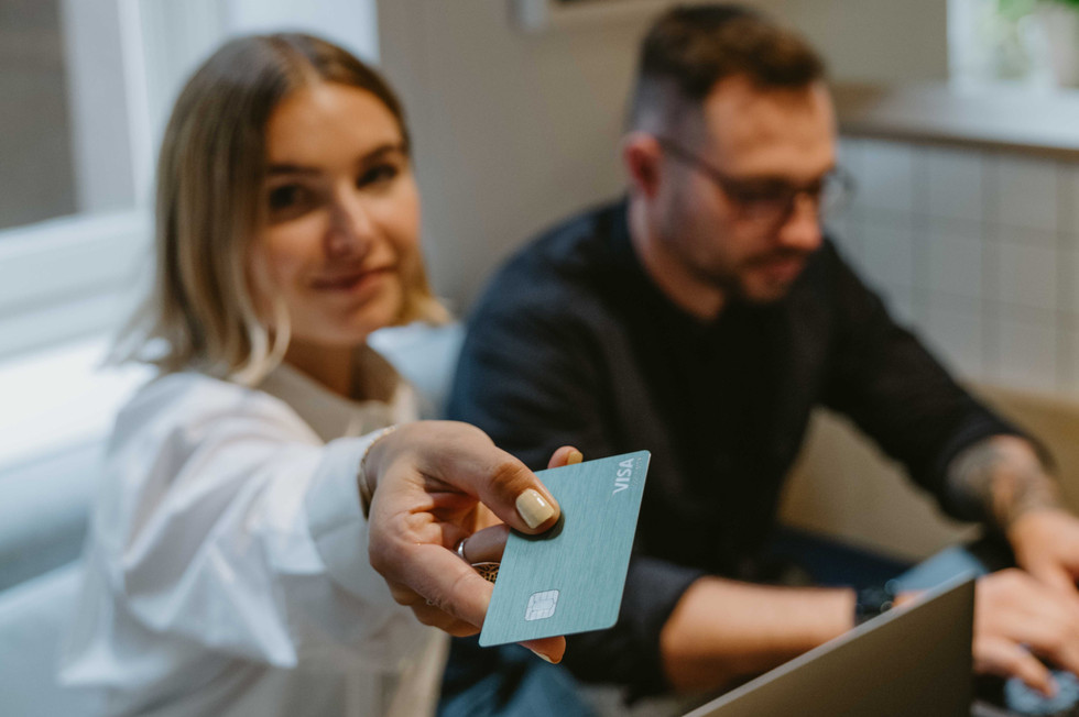 Employee showing her Payhawk corporate  Visa card