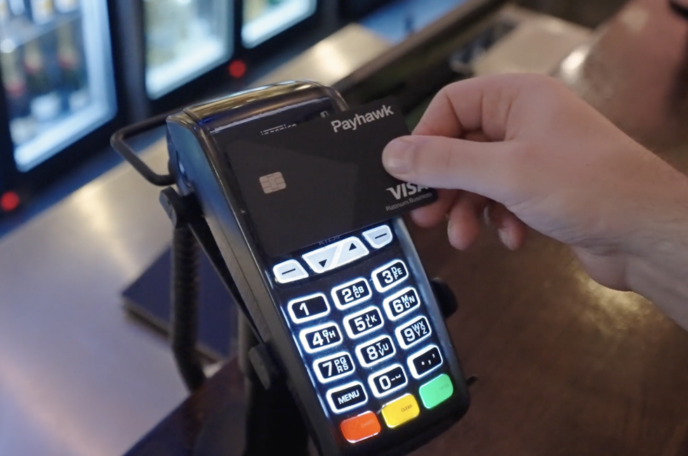 Employee paying with Payhawk's Corporate Credit Card at the counter