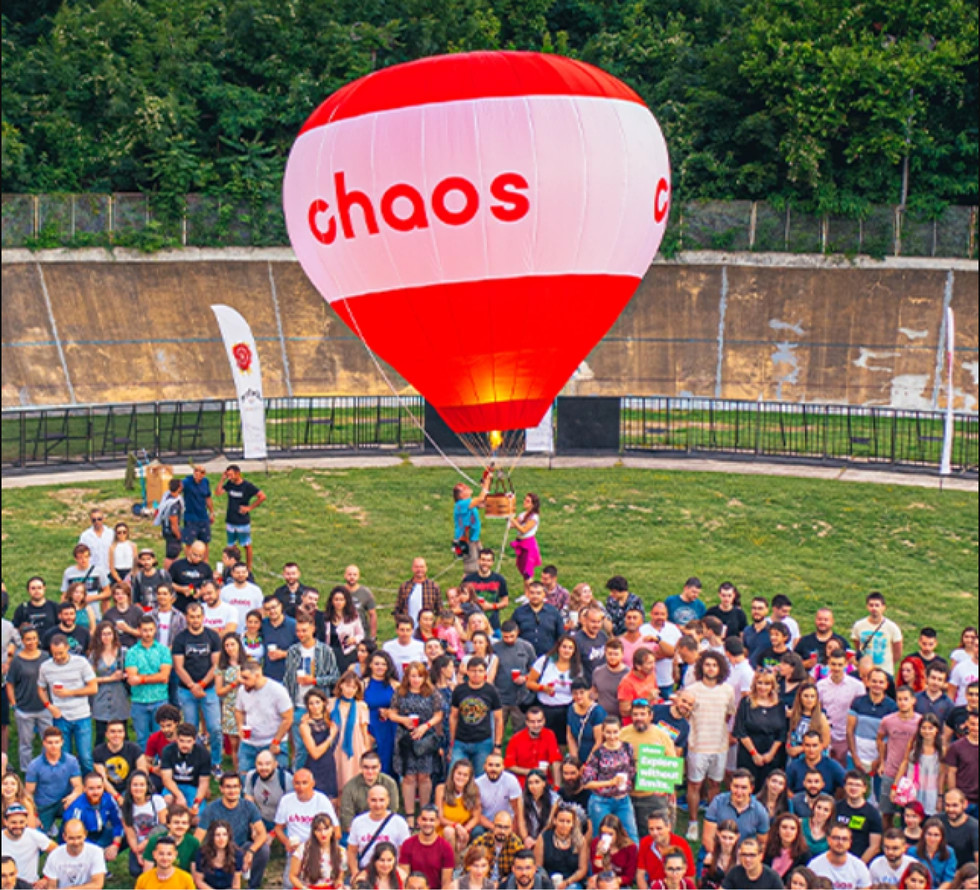 The Chaos Group team gathered on a field with a hot air balloon