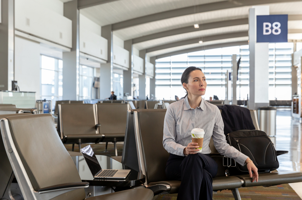 Employee evaluating Pros and Cons Of Prepaid Business Travel Cards in the airport