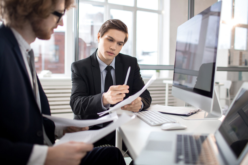 An accountant working on reconciling finances between multiple entities automatically using Payhawk spend management solution. 