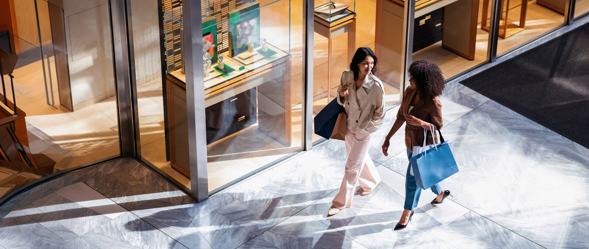 Images of women walking in a shopping center