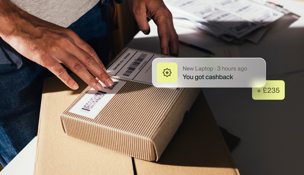 An image showing an employee receiving a package with a new laptop and a Payhawk notification about receiving cashback for the purchase