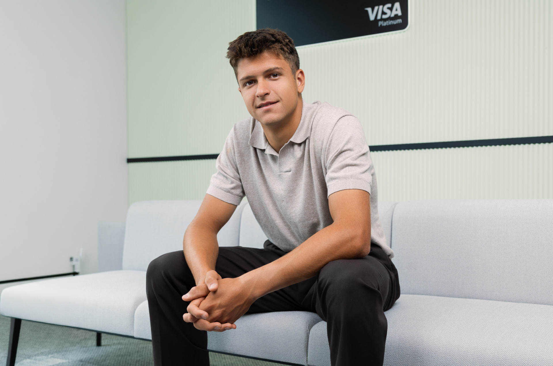 A portrait shot of Alexander Vasilev wearing a tennis jersey with a Payhawk logo
