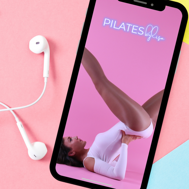 Lisa using a mobile phone with headphones, likely during a Pilates session for her online studio.
