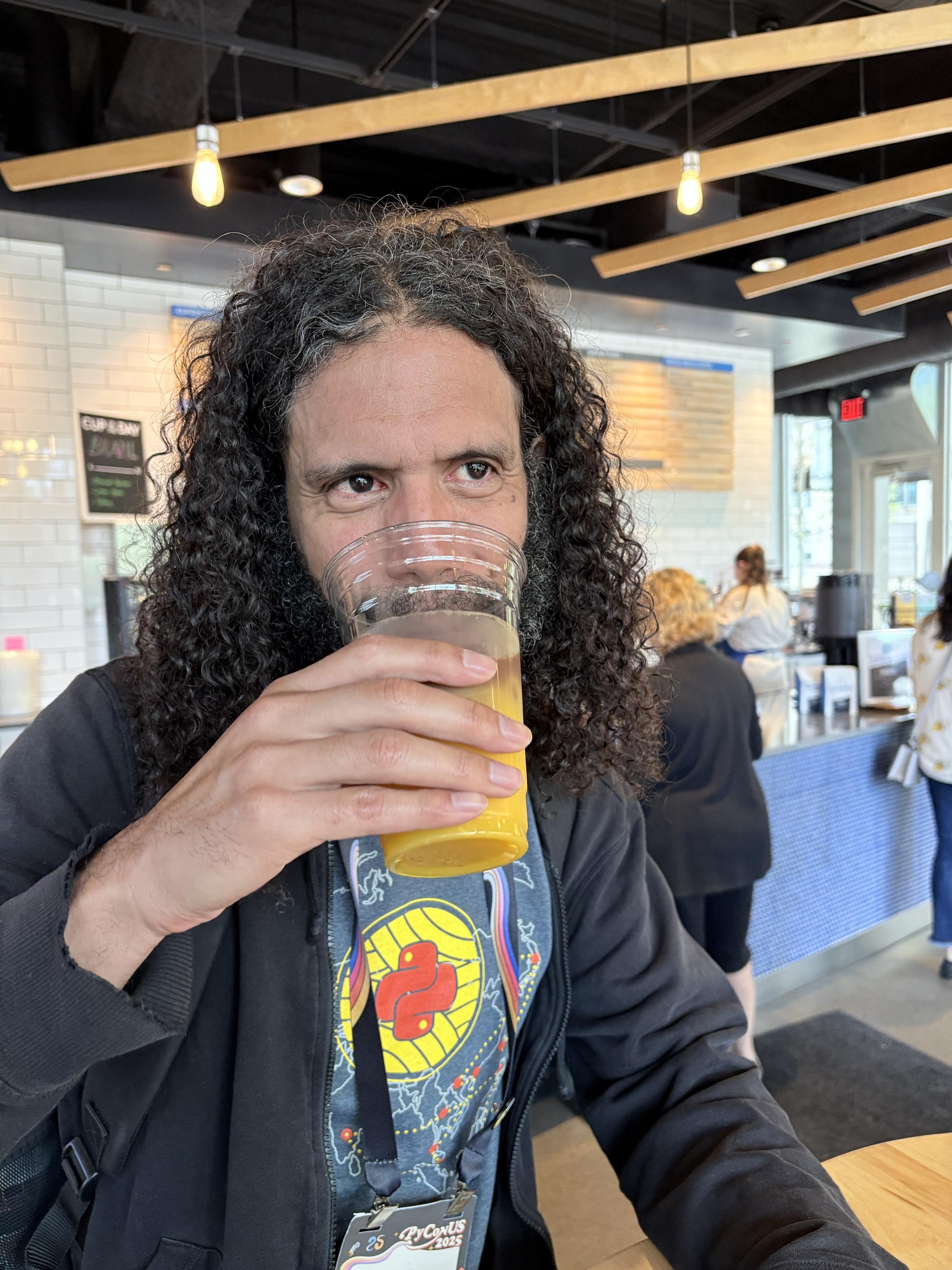 I'm drinking what looks to be orange juice with a bit of brown stuff in it.