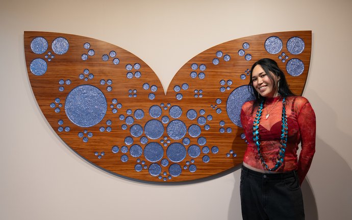 Maioha Kara with her exhibition at Pātaka