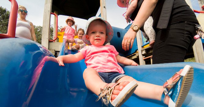 hero image - baby on slide at playground