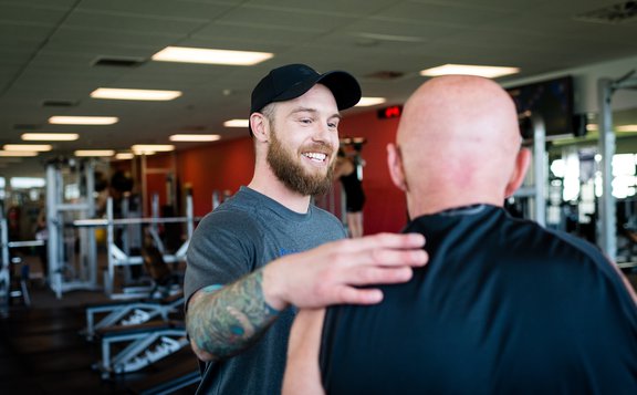 Fitness centre staff with gym member