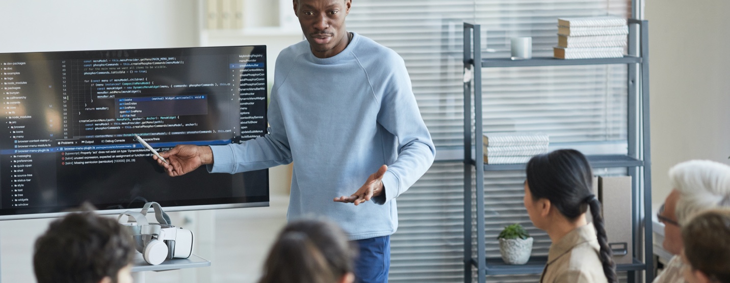 Man presenting his code for review in front of his team