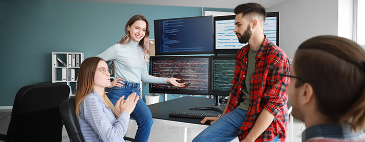 Group of web developers discussing latest code push