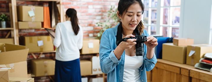 Two young eCommerce retailers taking product catalog photos