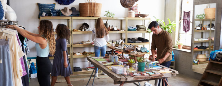 Shoppers browsing clothing in a chic pop-up shop